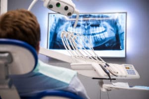 Dentist patient looking at a dental x-ray image