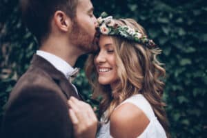 Bride with whitened teeth hugs her new husband on their wedding day