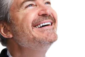 Man in his 50s has great teeth after filling in a gap with a dental bridge